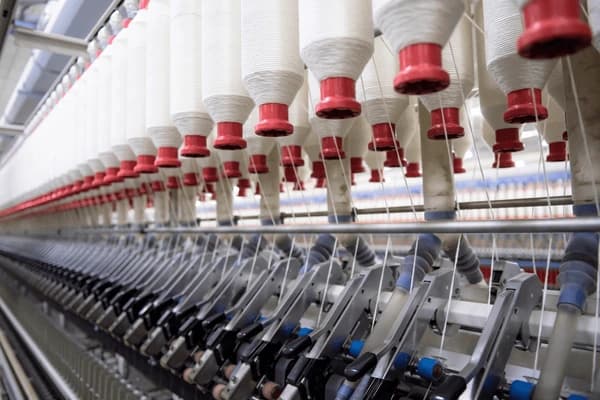 Industrial yarn mill with white thread spools
